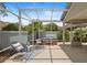 The screened in lanai has outdoor chairs and a spa, providing a relaxing experience at 1664 Vinewood Ave, The Villages, FL 32162