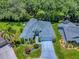 Aerial view of the home and neighborhood showcases a home with a well-manicured lawn and mature landscaping at 17037 Se 76Th Creekside Cir, The Villages, FL 32162