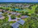 Aerial view shows a home on a landscaped cul-de-sac lot with golf course views, mature trees, and nearby pond at 17037 Se 76Th Creekside Cir, The Villages, FL 32162