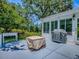 Back patio includes a grill, seating, and access to a bright sunroom overlooking the backyard at 17037 Se 76Th Creekside Cir, The Villages, FL 32162