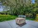 Manicured backyard with a grassy lawn and landscaping provides a tranquil outdoor living space with a fire pit feature at 17037 Se 76Th Creekside Cir, The Villages, FL 32162