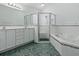 Bathroom features a dual sink vanity, walk-in shower, and jetted tub at 17037 Se 76Th Creekside Cir, The Villages, FL 32162