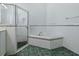 Bright bathroom featuring a shower and a soaking tub with decorative tile accents at 17037 Se 76Th Creekside Cir, The Villages, FL 32162