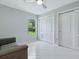 Bedroom featuring a ceiling fan, closet, window and tile flooring at 17037 Se 76Th Creekside Cir, The Villages, FL 32162