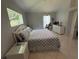 Bedroom featuring a comfortable bed and a serene ambiance with bright natural light at 17037 Se 76Th Creekside Cir, The Villages, FL 32162