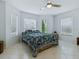 Bedroom with a ceiling fan, three windows with blinds, and tile flooring at 17037 Se 76Th Creekside Cir, The Villages, FL 32162