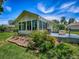 Exterior view from the side of the property shows a well-maintained yard with mature landscaping and access to the back patio at 17037 Se 76Th Creekside Cir, The Villages, FL 32162