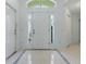 Bright foyer with tile flooring, decorative door accents, and ample natural light at 17037 Se 76Th Creekside Cir, The Villages, FL 32162