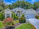 Charming home featuring a well manicured front yard with flowerbeds and trees at 17037 Se 76Th Creekside Cir, The Villages, FL 32162