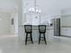 Open concept kitchen with barstool seating at the counter and stainless steel appliances at 17037 Se 76Th Creekside Cir, The Villages, FL 32162