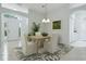 Staged living room featuring tile flooring, arched doorways, and modern furnishings at 17037 Se 76Th Creekside Cir, The Villages, FL 32162