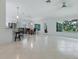 Bright living space with a breakfast bar, dining table, tile flooring, and ample natural light at 17037 Se 76Th Creekside Cir, The Villages, FL 32162