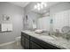 Bathroom features double sinks with granite counters and decorative light fixtures at 17439 Promenade Dr, Clermont, FL 34711
