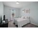 Serene bedroom with a comfortable bed, a window with natural light, and neutral decor at 17439 Promenade Dr, Clermont, FL 34711