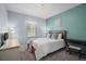 Cozy bedroom with a comfortable bed, a ceiling light, and a view from a window at 17439 Promenade Dr, Clermont, FL 34711