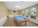 Community game room with billiard table, natural light, and comfortable seating at 17439 Promenade Dr, Clermont, FL 34711
