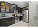 Well-equipped kitchen with stainless steel appliances and dark cabinetry at 17439 Promenade Dr, Clermont, FL 34711