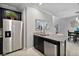 A modern kitchen featuring stainless steel appliances, granite countertops, and ample natural light at 17439 Promenade Dr, Clermont, FL 34711