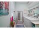 Clean laundry room features storage shelves, bright light, and decorative mirror at 17439 Promenade Dr, Clermont, FL 34711