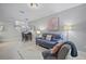Bright living room featuring tile flooring and a cozy seating arrangement at 17439 Promenade Dr, Clermont, FL 34711