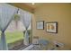 Relaxing patio area with table, chairs, and sheer curtains for privacy and shade at 17439 Promenade Dr, Clermont, FL 34711