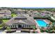 Aerial view of community clubhouse with pool and lush landscaping in a great neighborhood at 17439 Promenade Dr, Clermont, FL 34711
