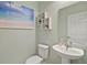 Stylish powder room featuring a pedestal sink, modern fixtures, and tasteful decor at 17439 Promenade Dr, Clermont, FL 34711