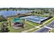 Recreational amenities showing tennis and pickleball courts, with a playground area, and a scenic lake view at 17439 Promenade Dr, Clermont, FL 34711