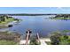 Expansive lake view featuring a dock with a gazebo, a boat ramp and a large waterway for boating and watersports at 17439 Promenade Dr, Clermont, FL 34711