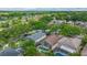 Aerial shot showcasing the neighborhood, featuring homes with screened-in pools and mature trees at 1906 Chathamoor Dr, Orlando, FL 32835