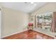 Cozy bedroom with laminated floors and a sunny window overlooking the pool at 1906 Chathamoor Dr, Orlando, FL 32835