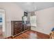 Charming bedroom featuring wood floors, dresser and chest with mirror, and window providing natural light at 1906 Chathamoor Dr, Orlando, FL 32835