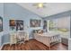 Charming bedroom featuring a cozy bed, laminate floors, and a bright window at 1906 Chathamoor Dr, Orlando, FL 32835
