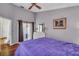 Comfortable bedroom with wood floors and access to a balcony through draped sliding glass door at 1906 Chathamoor Dr, Orlando, FL 32835