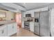 Well-lit kitchen with stainless steel appliances, white cabinets, and a view into the dining area at 1906 Chathamoor Dr, Orlando, FL 32835