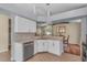 Modern kitchen features sleek white cabinets, stainless steel appliances, and tiled flooring at 1906 Chathamoor Dr, Orlando, FL 32835