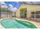 Inviting screened-in pool area featuring a spacious patio, serene atmosphere and seamless indoor-outdoor living at 1906 Chathamoor Dr, Orlando, FL 32835