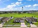 Aerial view of a neighborhood showcasing the property lines of a single-Gathering home with large lawn and green spaces at 1940 Piedmont Ct, Mascotte, FL 34753