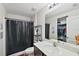 Bathroom featuring a shower with curtain, toilet, vanity and a view of the walk-in closet at 1940 Piedmont Ct, Mascotte, FL 34753