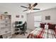Bedroom features a gaming setup, a comfortable bed, and a bright window at 1940 Piedmont Ct, Mascotte, FL 34753