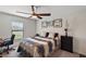 This bedroom offers a ceiling fan, artwork, and great natural light from a window at 1940 Piedmont Ct, Mascotte, FL 34753
