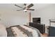 Comfortable bedroom featuring a ceiling fan, a dresser, and a stylish patterned bedspread at 1940 Piedmont Ct, Mascotte, FL 34753