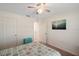 Bright bedroom features a closet, doors, and a turquoise nightstand with storage at 1940 Piedmont Ct, Mascotte, FL 34753