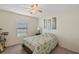 Bright bedroom featuring a ceiling fan, a window, and stylish wall art at 1940 Piedmont Ct, Mascotte, FL 34753