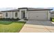 Well-maintained home with a two-car garage, neutral paint, and landscaped front yard adding curb appeal at 1940 Piedmont Ct, Mascotte, FL 34753