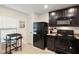 This kitchen features black appliances, tile floors and a cozy breakfast nook at 1940 Piedmont Ct, Mascotte, FL 34753