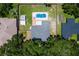 An aerial shot shows the house, in-ground pool, green backyard, and neighborhood at 204 Lori Ct, Umatilla, FL 32784
