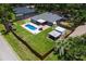 Aerial view of the property featuring a private pool, a large backyard, and mature trees at 204 Lori Ct, Umatilla, FL 32784