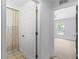 Bright bathroom view featuring a tile floor, shower with curtain and a doorway to bedroom at 204 Lori Ct, Umatilla, FL 32784