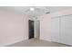 Empty bedroom featuring light pink walls, carpet, ceiling fan, window and a black door to hall at 204 Lori Ct, Umatilla, FL 32784